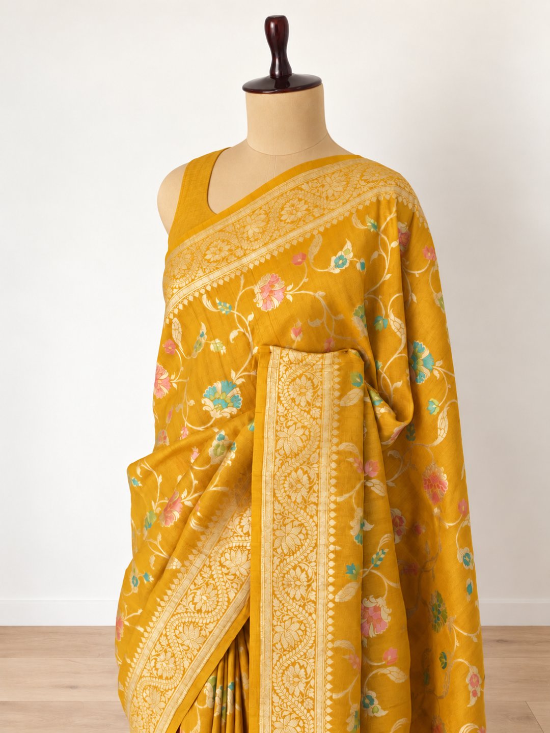 Mustard yellow with gold-toned zari and pastel pink, teal and green detailing Tussar Silk Banarasi saree front drape view