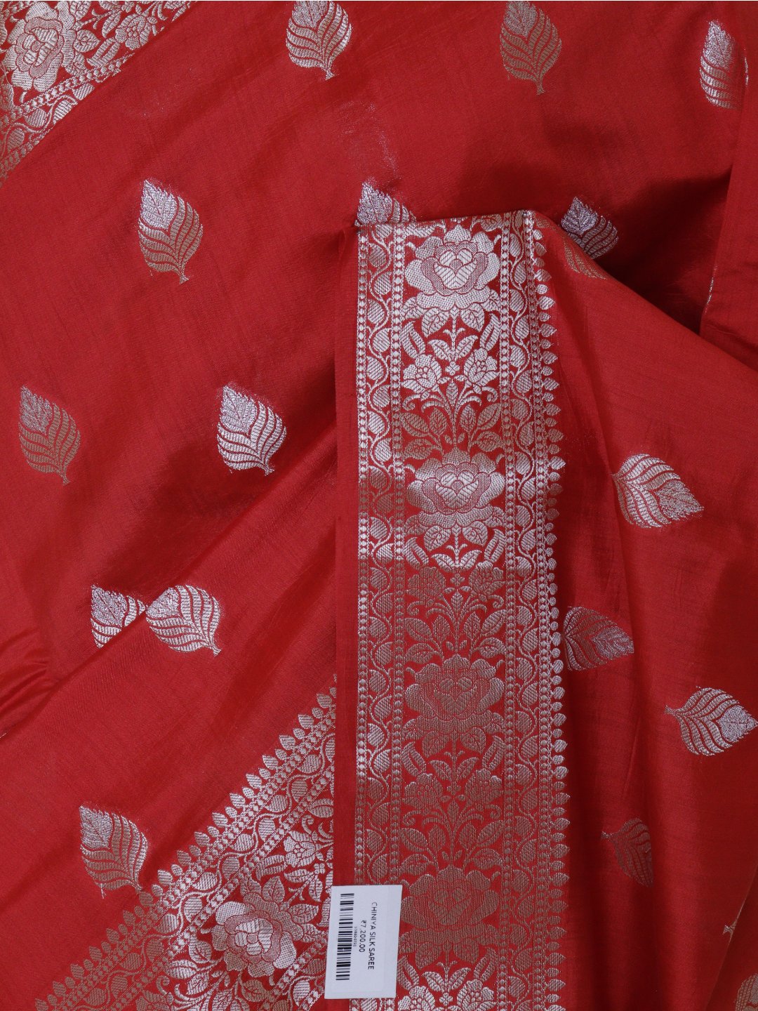 Bright red with silver-toned detailing Chiniya Silk Banarasi saree border closeup