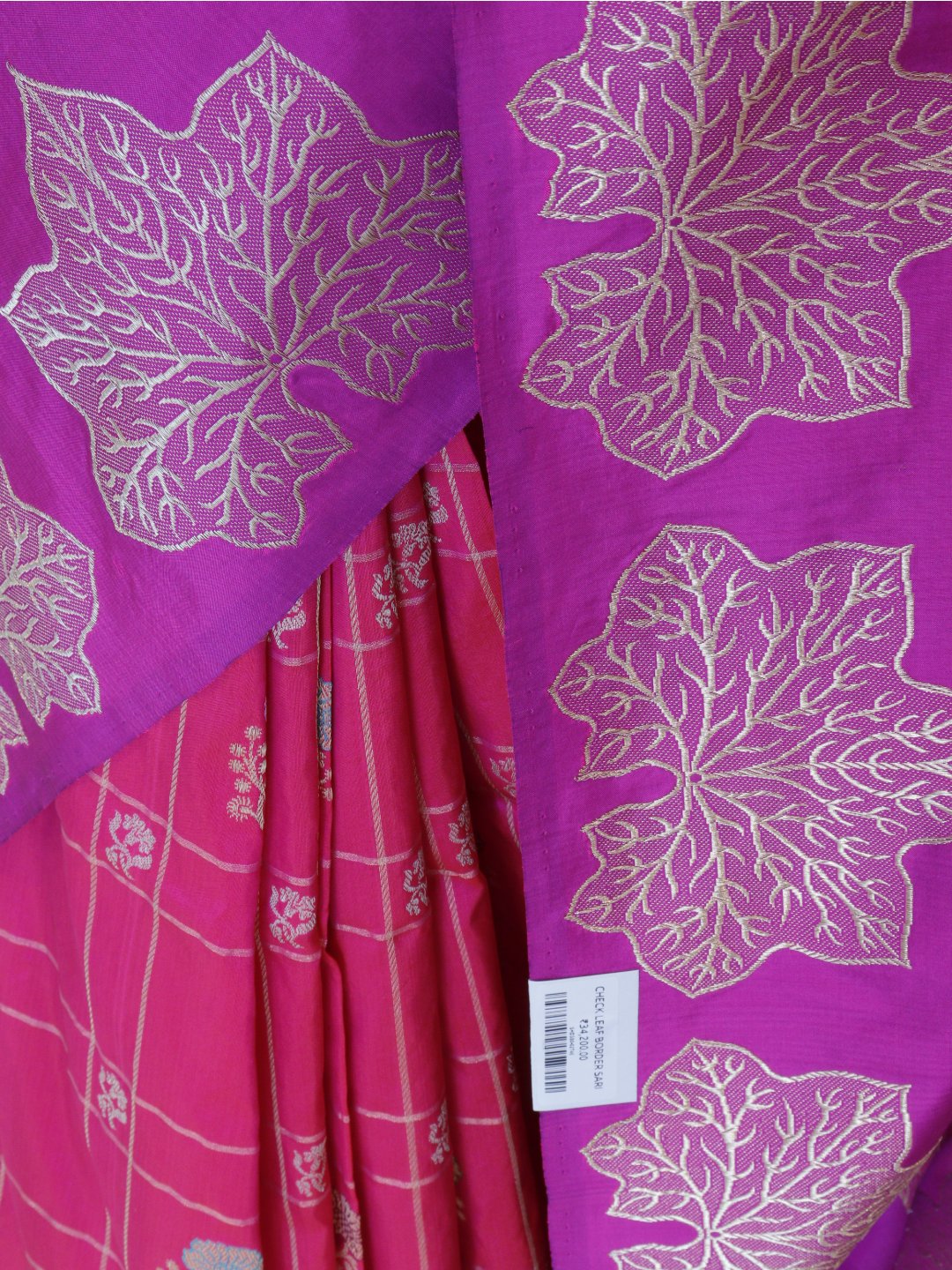 Rani pink with a contrasting purple border and pallu. Katan Silk Banarasi saree border closeup