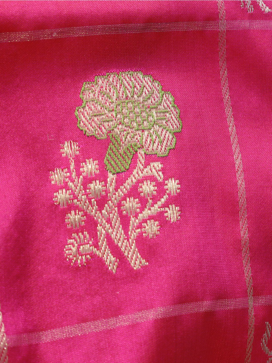 Rani pink with a contrasting purple border and pallu. Katan Silk Banarasi saree texture detail