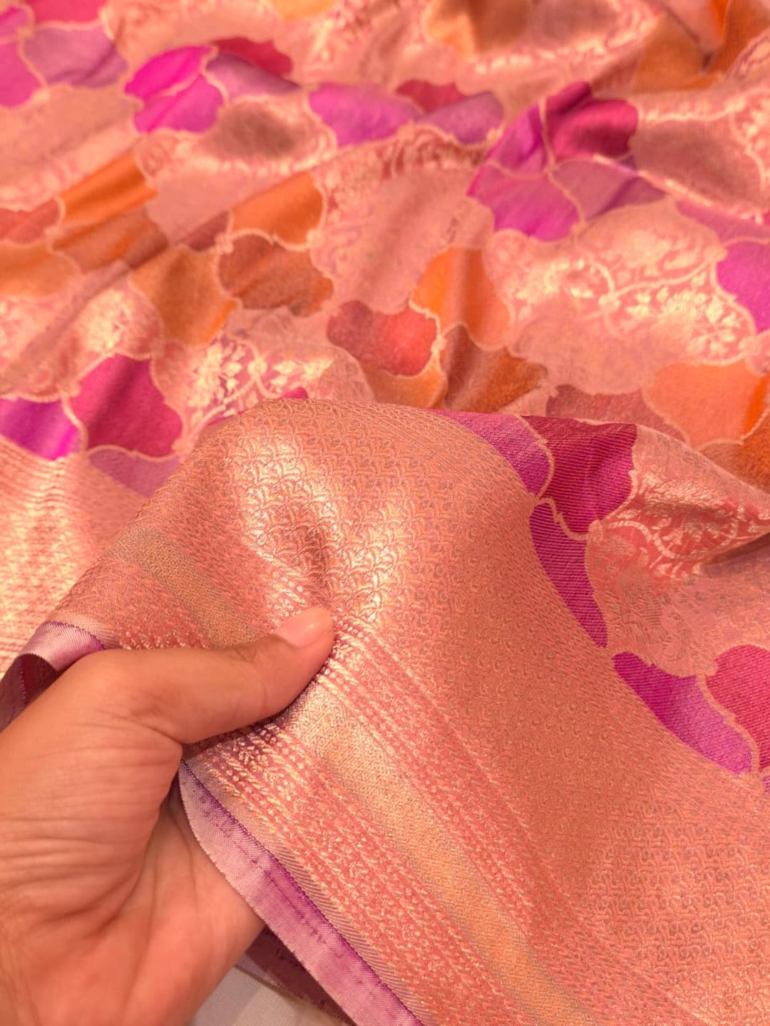 A soft peach and rose-gold base with pink, purple, orange and muted brown accents Mulbari silk Banarasi saree blouse piece