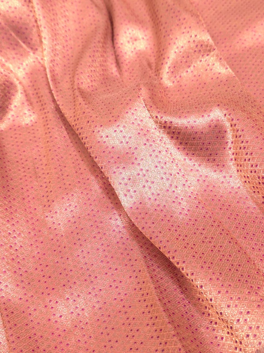A soft peach and rose-gold base with pink, purple, orange and muted brown accents Mulbari silk Banarasi saree zari work detail