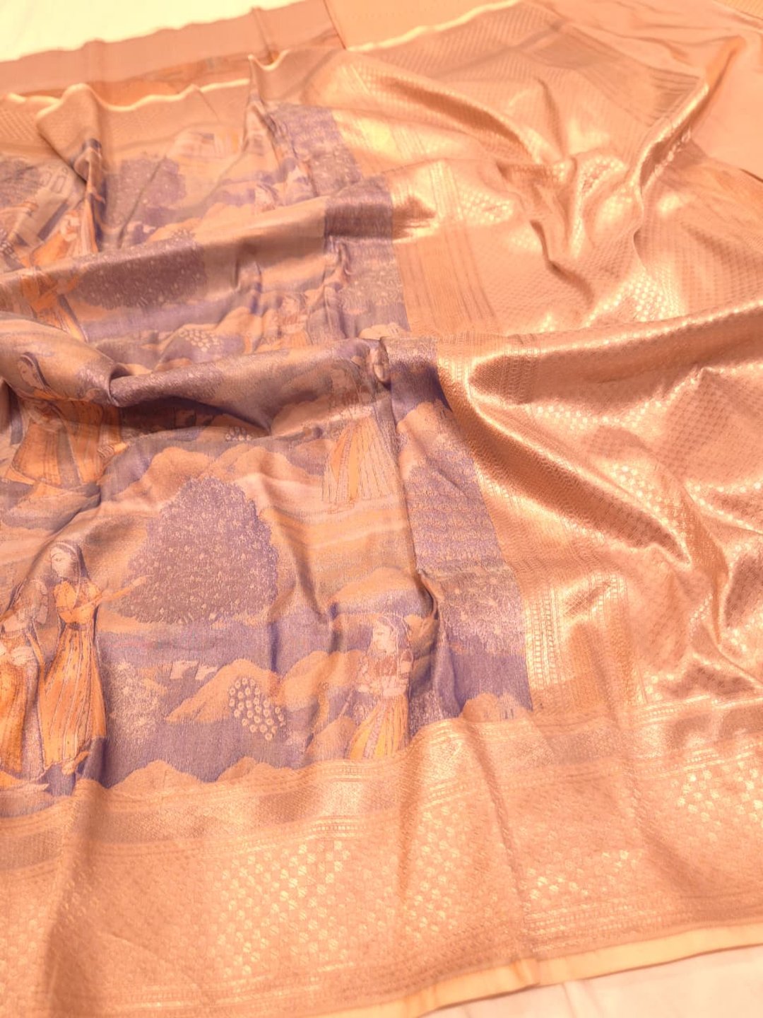 A muted lavender-grey base with peach, orange and gold-toned Mulbari Silk Banarasi saree texture detail
