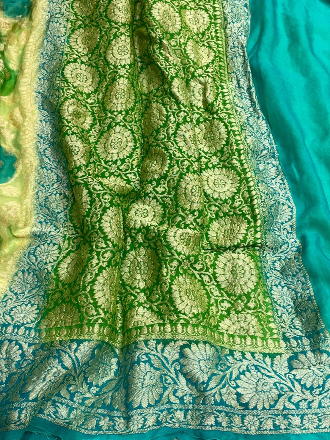 vibrant mix of light green and aqua blue. Chiffon Banarasi saree border closeup