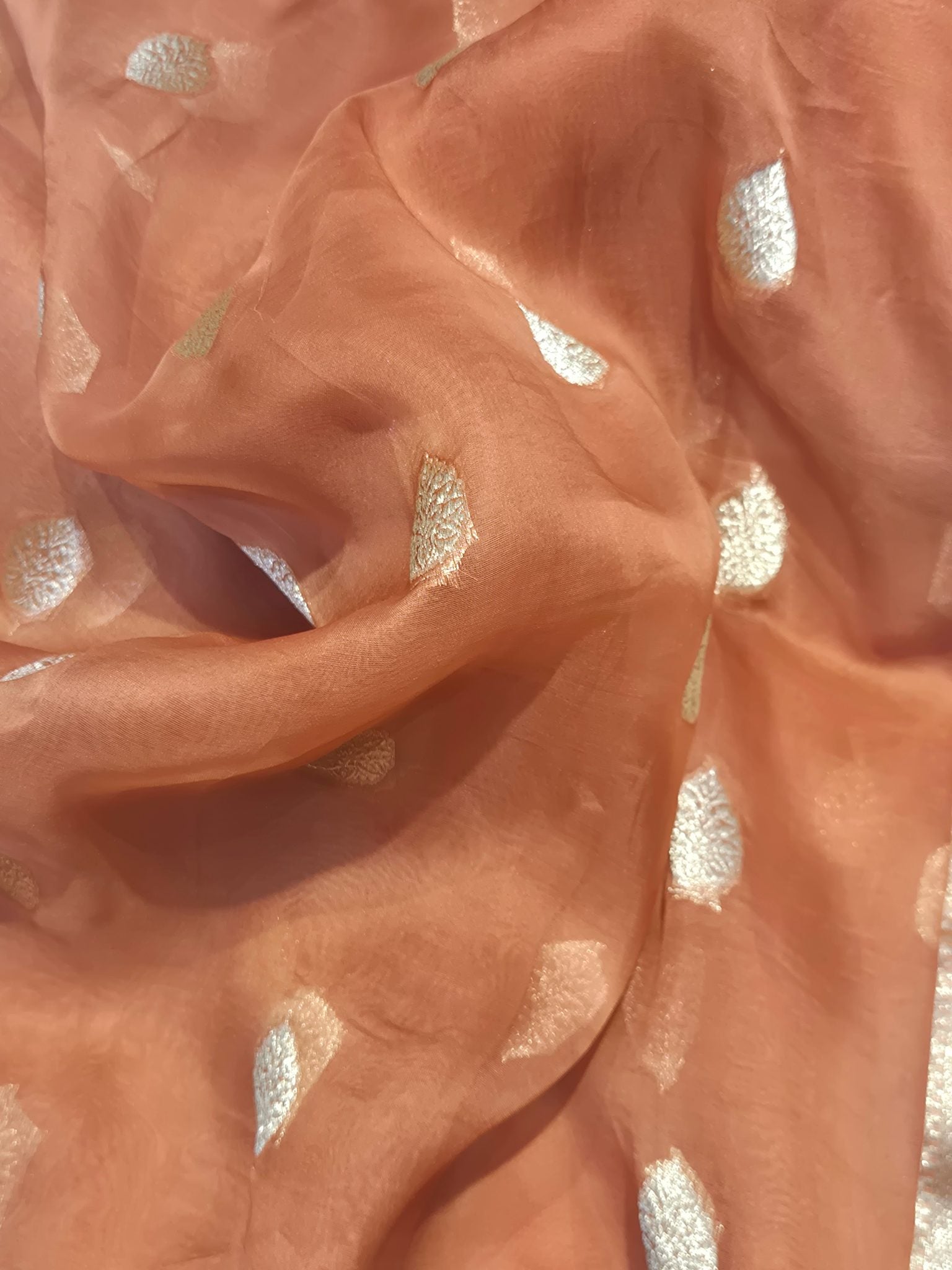 Warm Rust Peach Kora Silk Banarasi saree folded view