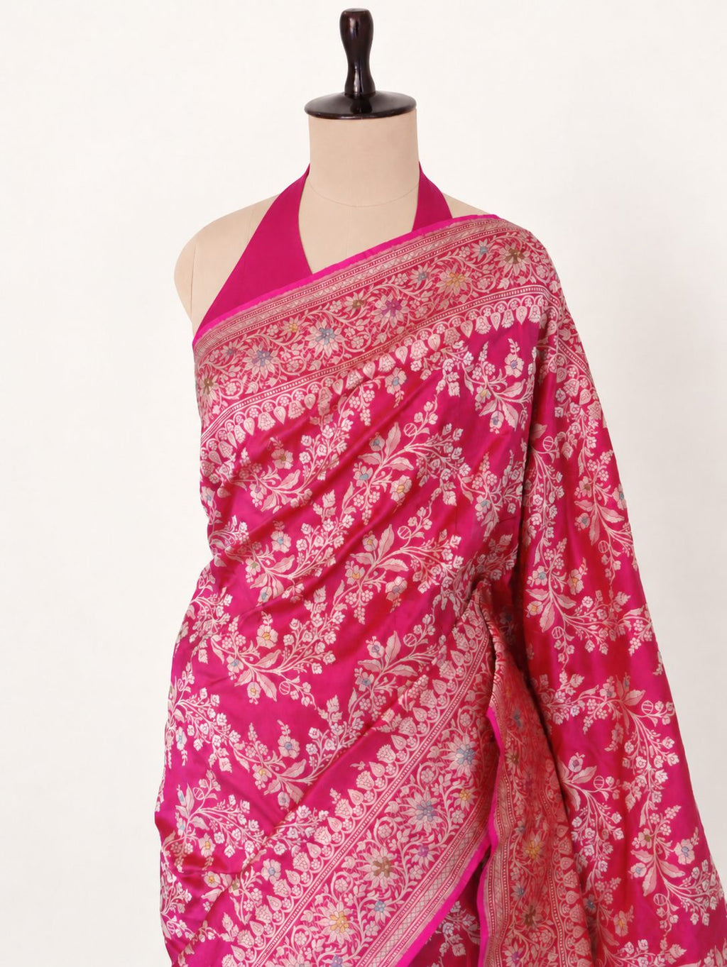 Vibrant rani pink with light gold-toned zari and multicoloured floral accents. Katan Silk Banarasi saree front drape view
