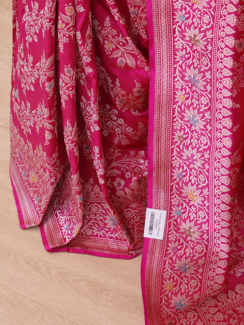 Vibrant rani pink with light gold-toned zari and multicoloured floral accents. Katan Silk Banarasi saree pallu detail