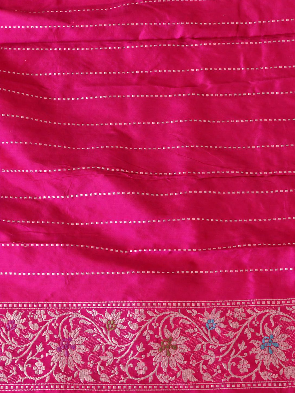 Vibrant rani pink with light gold-toned zari and multicoloured floral accents. Katan Silk Banarasi saree full spread