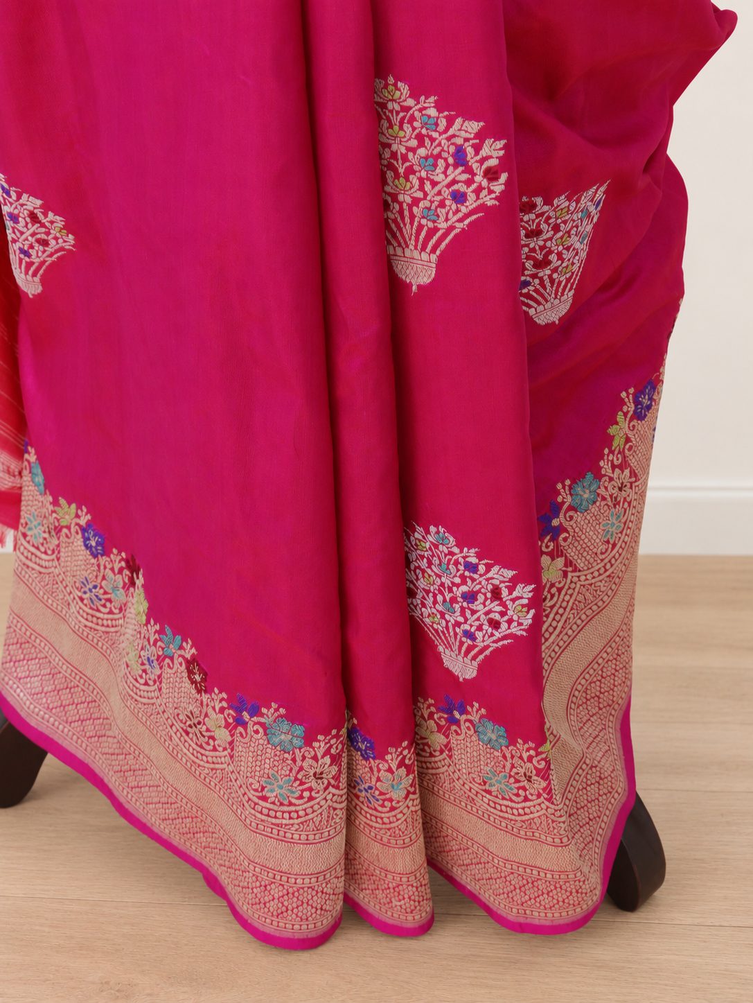 Rich rani pink with zari detailing and multicoloured Meenakari accents Katan Silk Banarasi saree border closeup