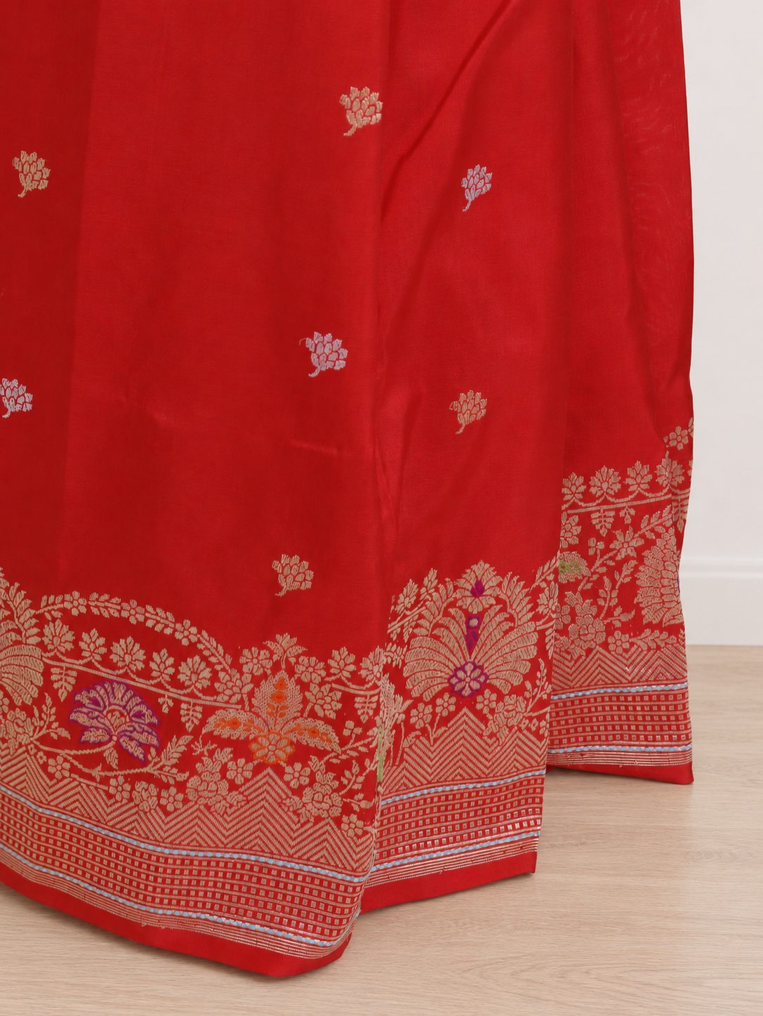 Vibrant vermilion red with gold-toned zari and purple, green and orange accents Katan Silk Banarasi saree pallu detail