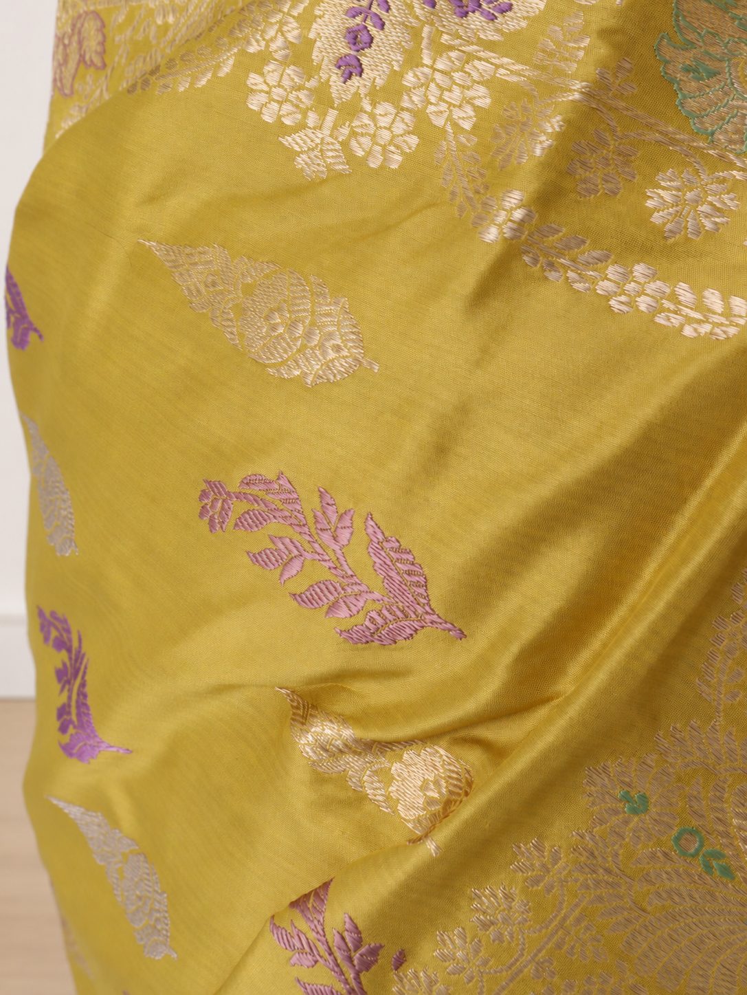 Mustard yellow with a subtle olive undertone, accented with lilac, mint green and light gold zari Katan Silk Banarasi saree border closeup