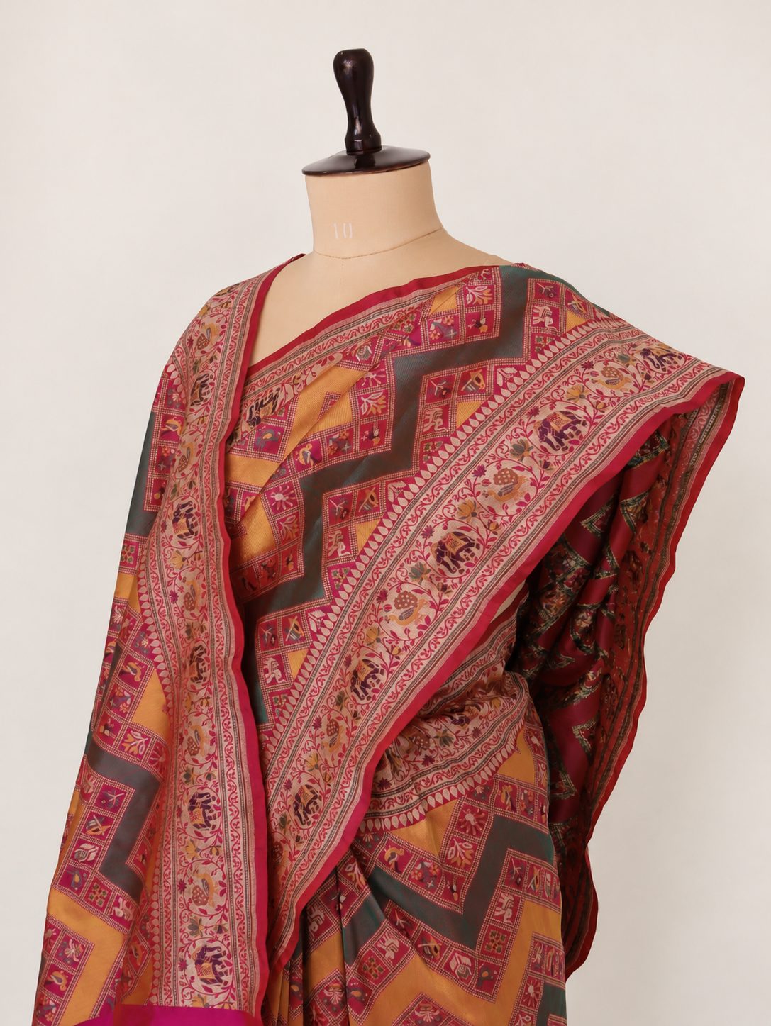 Mustard yellow and deep green, accented with rani pink, red edging and gold toned zari Katan Silk Banarasi saree front drape view