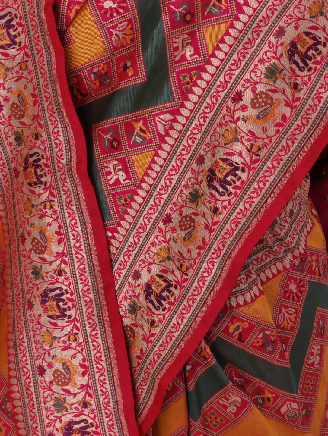 Mustard yellow and deep green, accented with rani pink, red edging and gold toned zari Katan Silk Banarasi saree front drape view