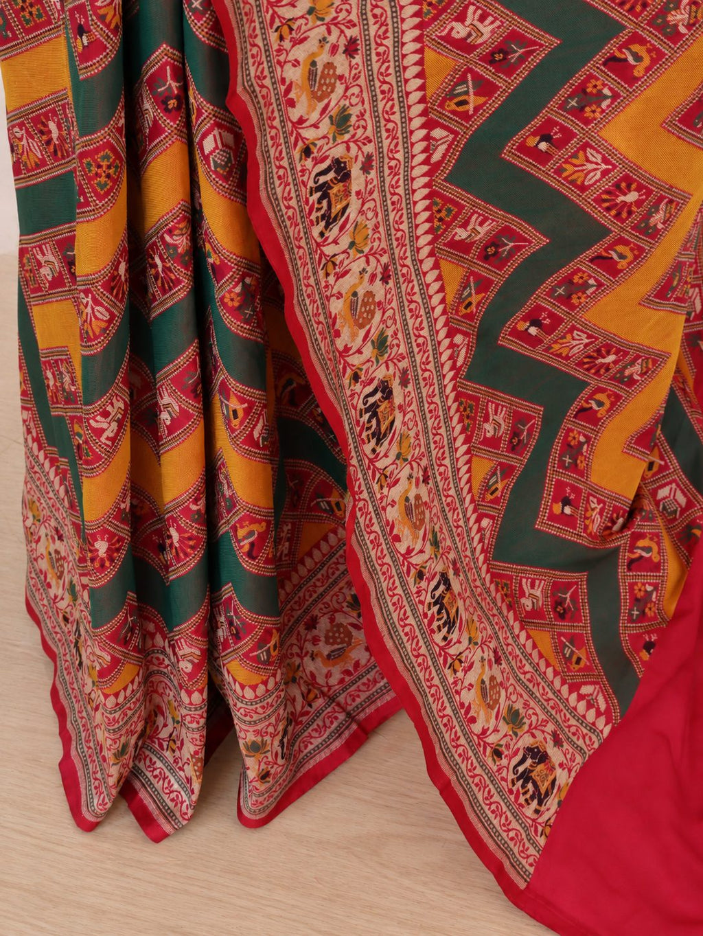 Mustard yellow and deep green, accented with rani pink, red edging and gold toned zari Katan Silk Banarasi saree front drape view