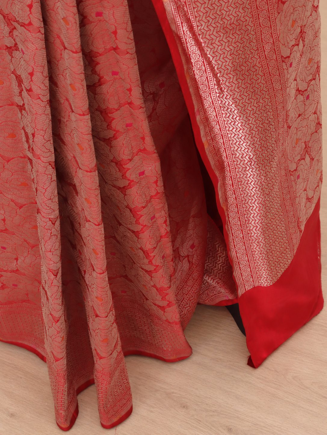 Rich red with metallic zari and subtle pink and orange Meenakari accents Katan Silk Banarasi saree border closeup