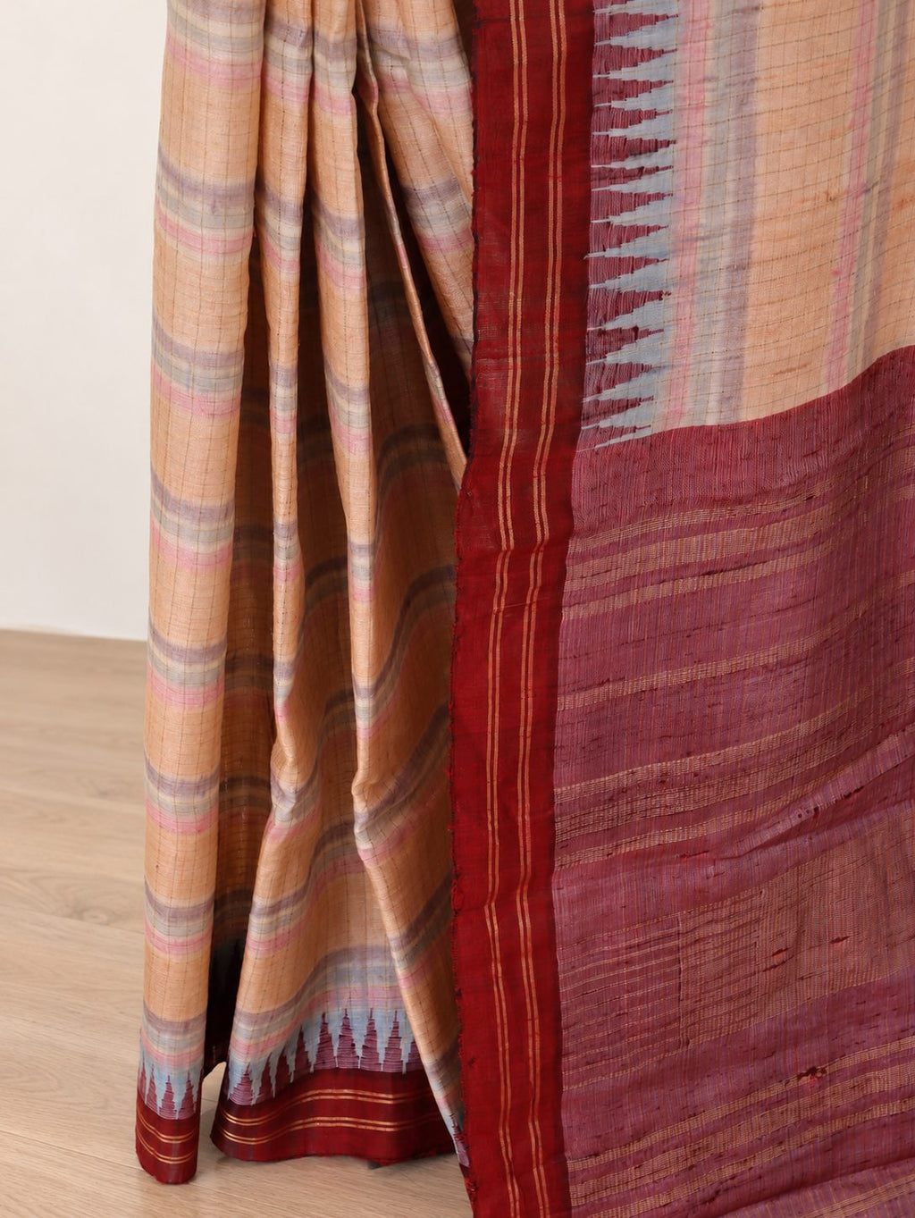 Soft peach-beige with pastel pink and powder-blue accents, contrasted by a deep maroon border Raw Silk Banarasi saree border closeup