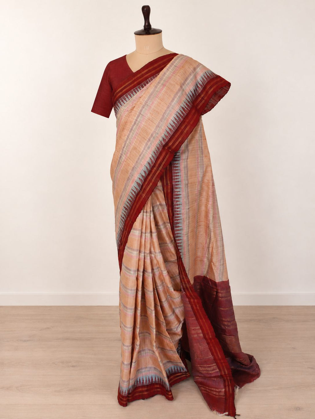 Soft peach-beige with pastel pink and powder-blue accents, contrasted by a deep maroon border Raw Silk Banarasi saree pallu detail