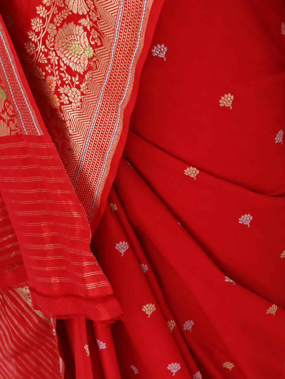Rich vermilion red with gold and silver-toned zari, accented with green, purple and orange details Katan Silk Banarasi saree pallu detail
