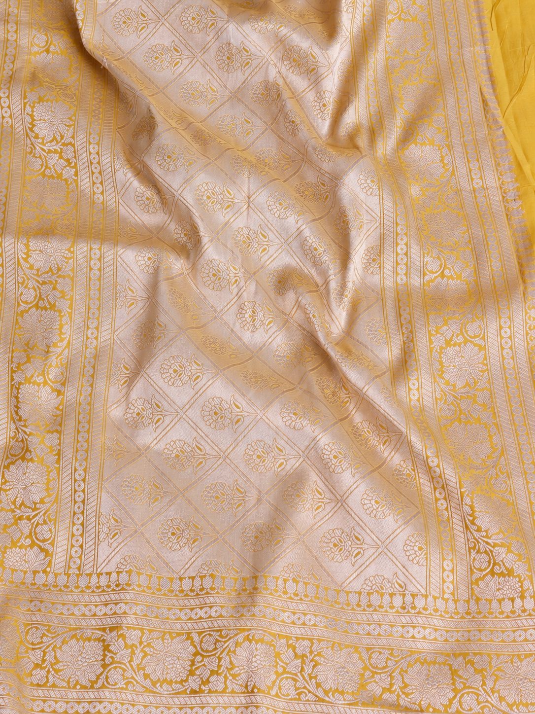 Rich haldi yellow with silver-toned woven detailing Katan Silk Banarasi saree texture detail