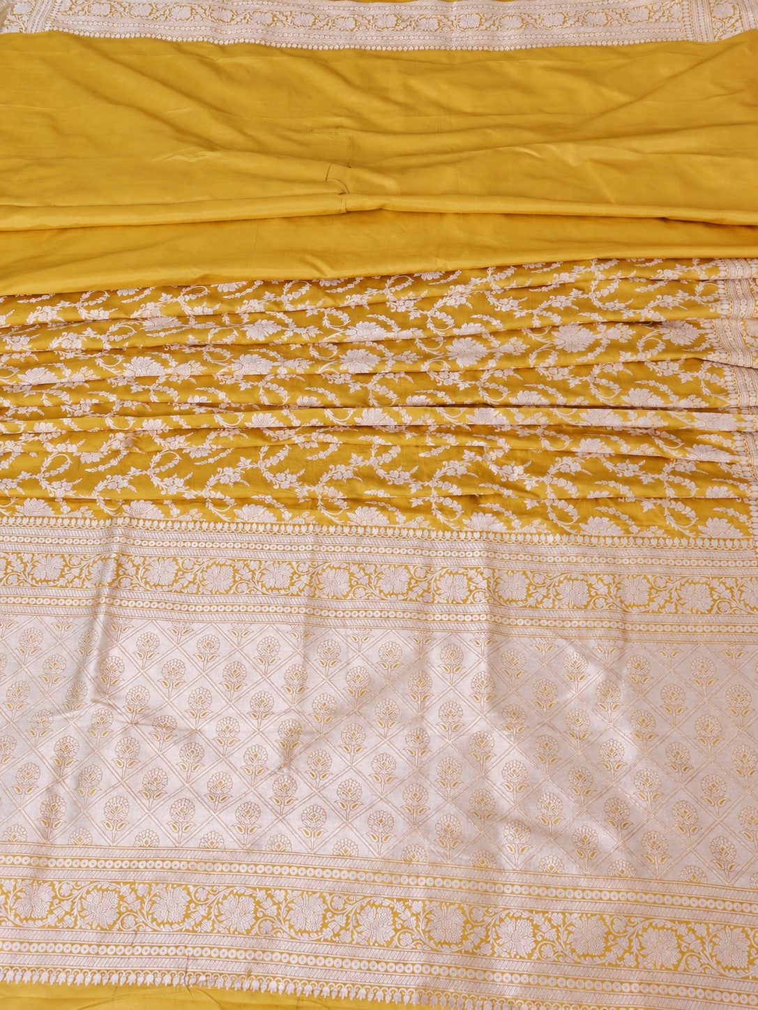 Rich haldi yellow with silver-toned woven detailing Katan Silk Banarasi saree pallu detail