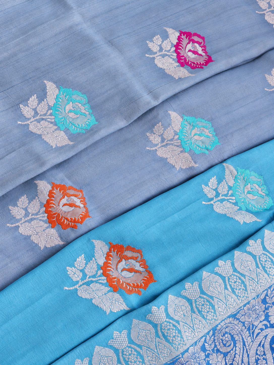 A soft steel-blue and aqua combination, complemented by a royal-blue pallu and silver-toned zari Tussar Silk Banarasi saree front drape view