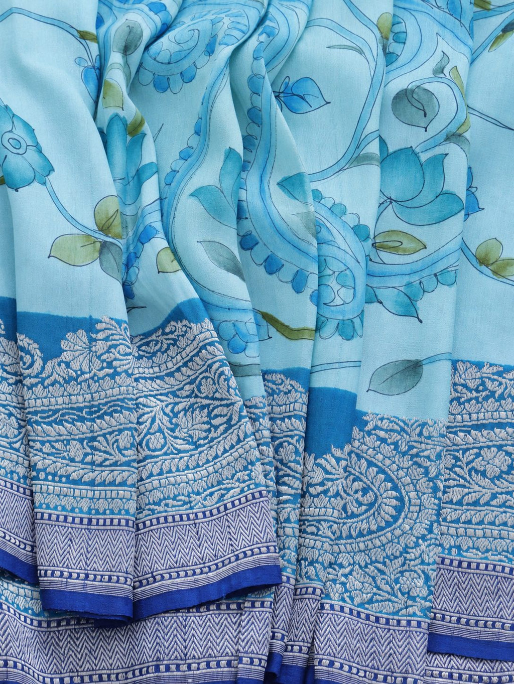 Soft aqua blue body with a contrasting royal blue pallu, blue floral detailing and touches of green Tussar Silk Banarasi saree border closeup