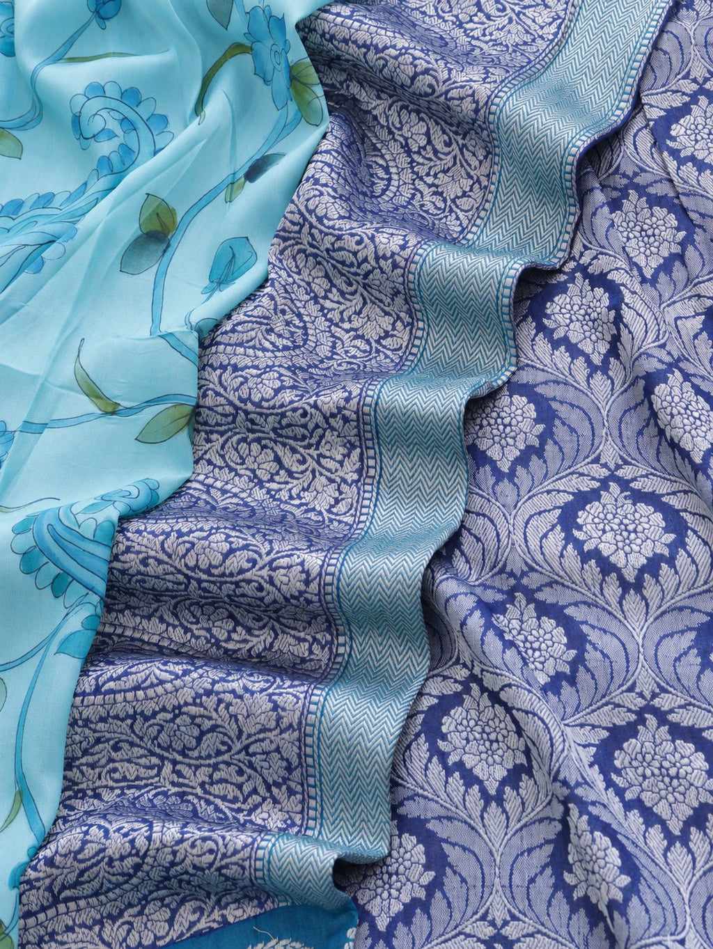 Soft aqua blue body with a contrasting royal blue pallu, blue floral detailing and touches of green Tussar Silk Banarasi saree front drape view