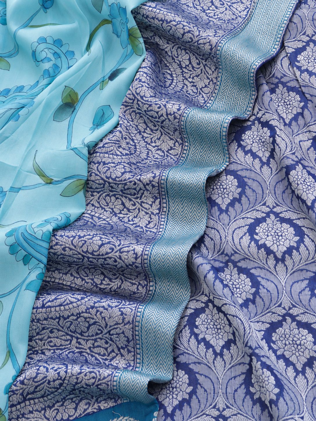 Soft aqua blue body with a contrasting royal blue pallu, blue floral detailing and touches of green Tussar Silk Banarasi saree front drape view