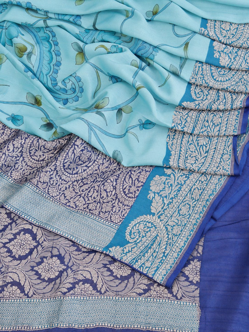 Soft aqua blue body with a contrasting royal blue pallu, blue floral detailing and touches of green Tussar Silk Banarasi saree blouse piece
