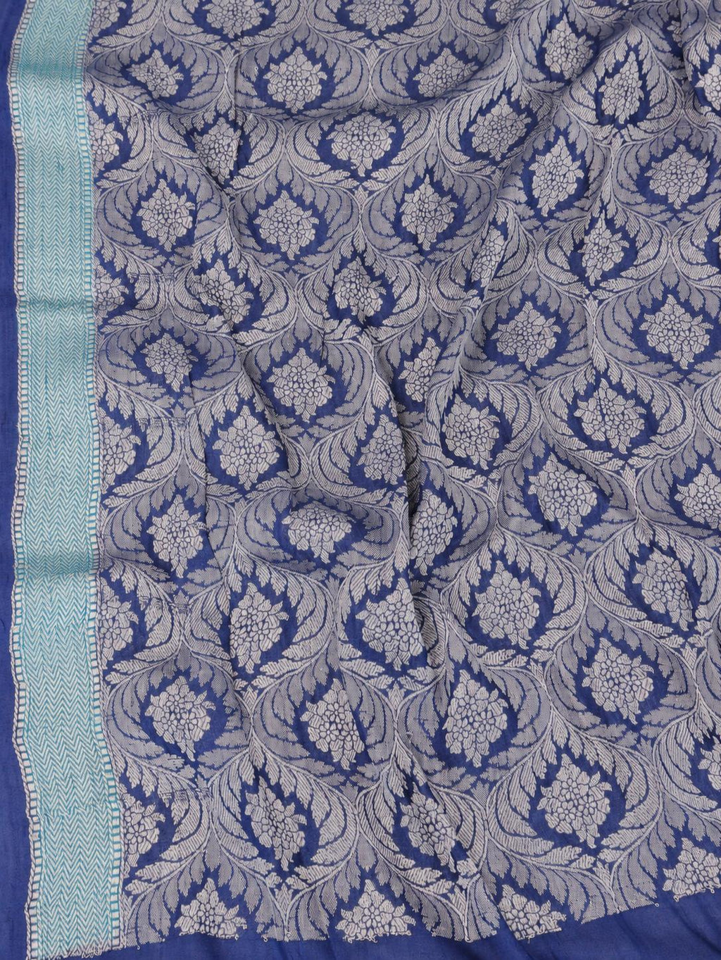 Soft aqua blue body with a contrasting royal blue pallu, blue floral detailing and touches of green Tussar Silk Banarasi saree full spread