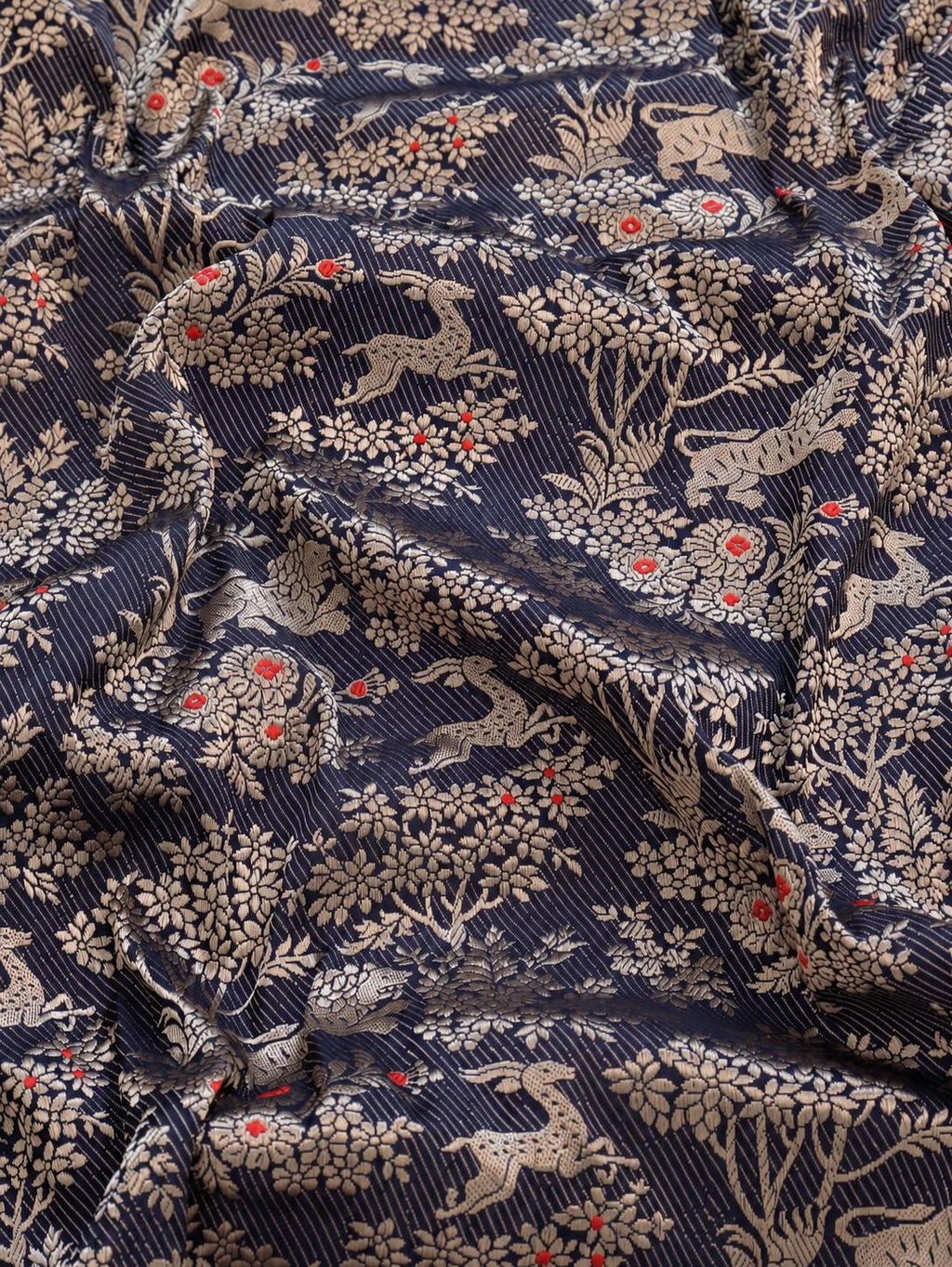 Deep navy blue with champagne gold zari and small red floral accents Katan Silk Banarasi saree border closeup