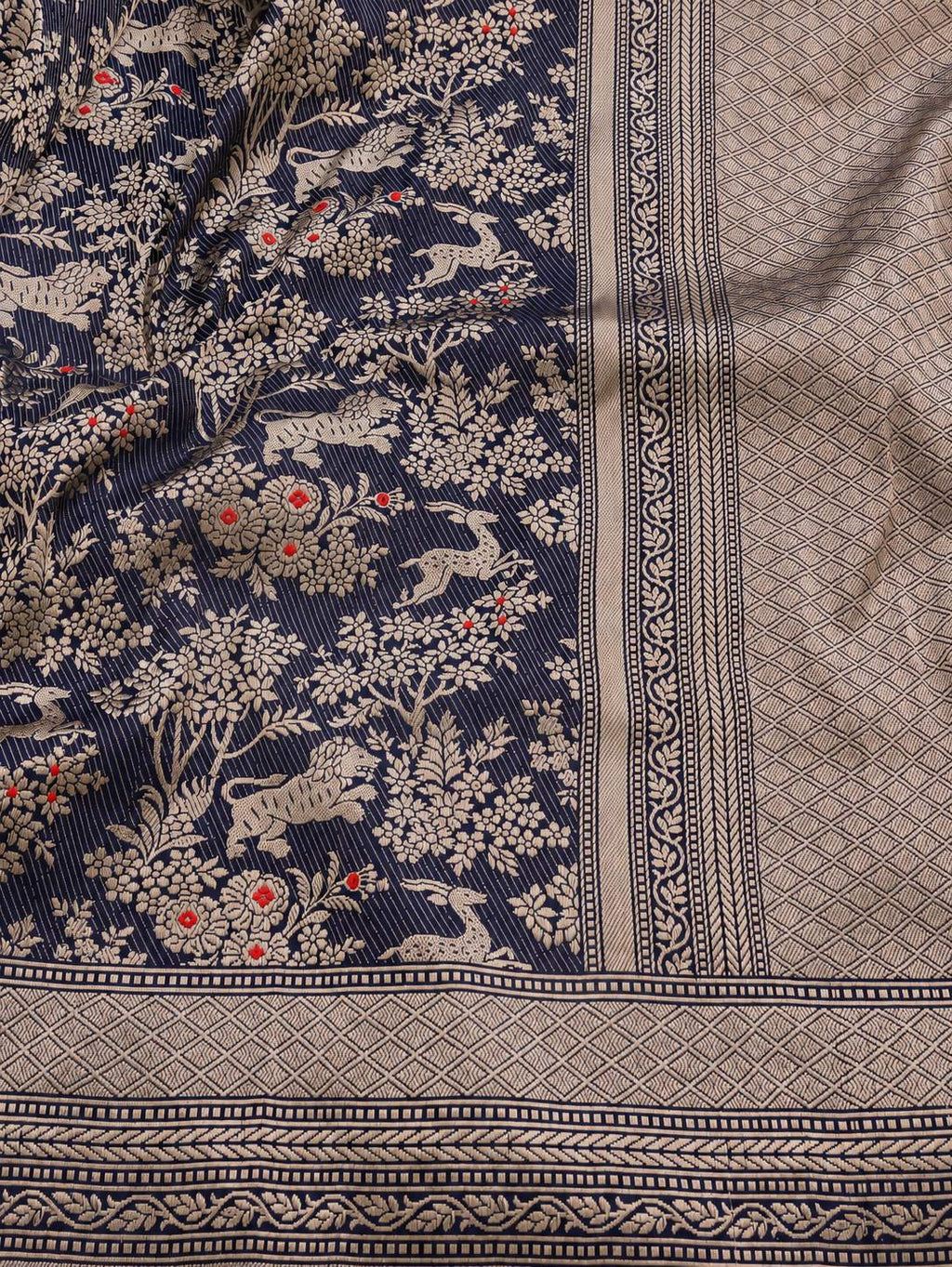 Deep navy blue with champagne gold zari and small red floral accents Katan Silk Banarasi saree texture detail