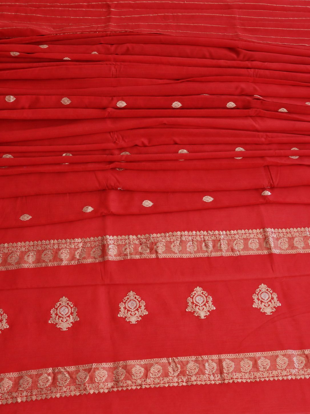 Vibrant vermilion red with delicate champagne-gold zari detailing Linen Cotton Banarasi saree zari work detail