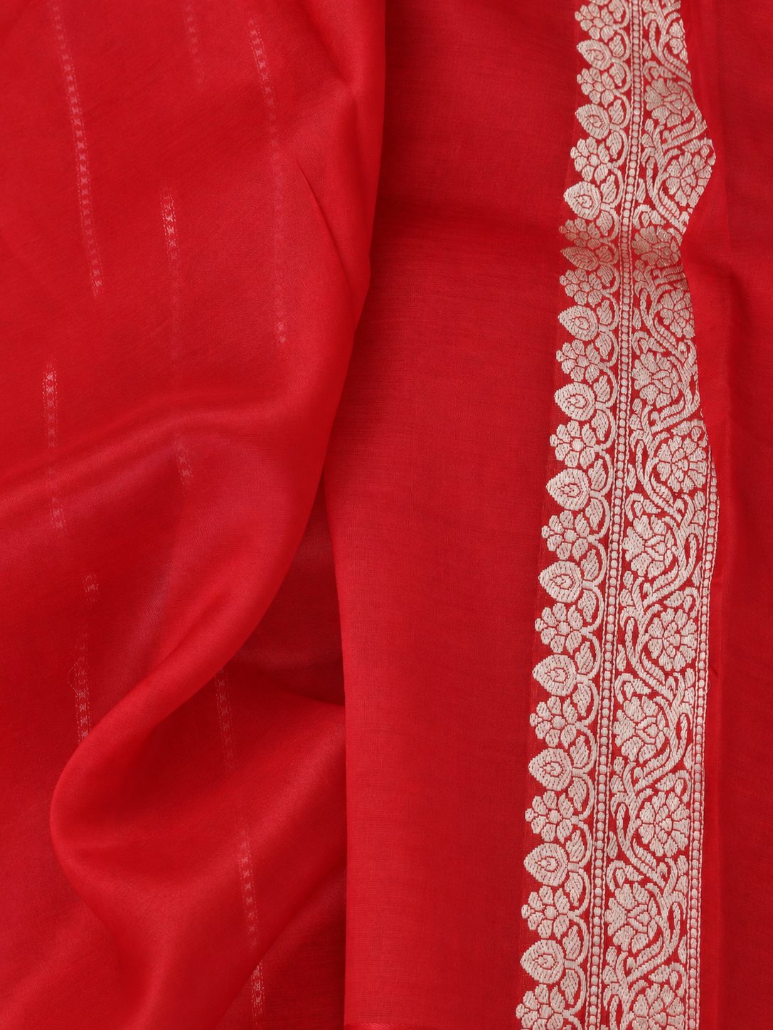 Rich vermilion red with silver-toned zari detailing Kora Silk Banarasi saree border closeup