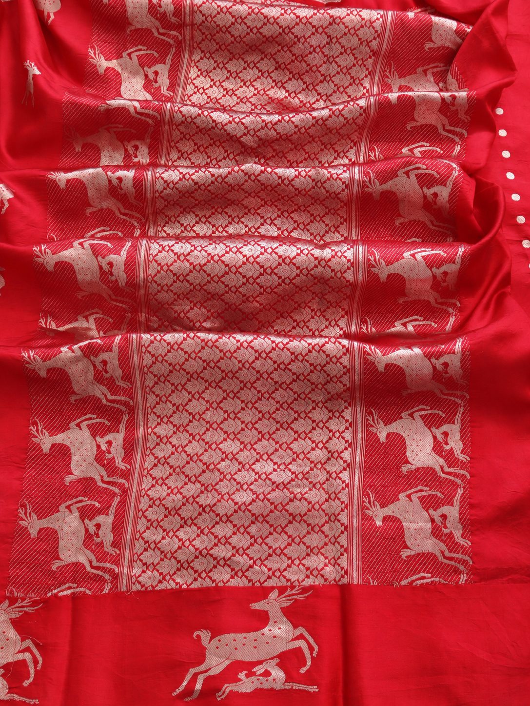 Rich cherry red with silver-toned woven detailing Soft Katan Banarasi saree front drape view