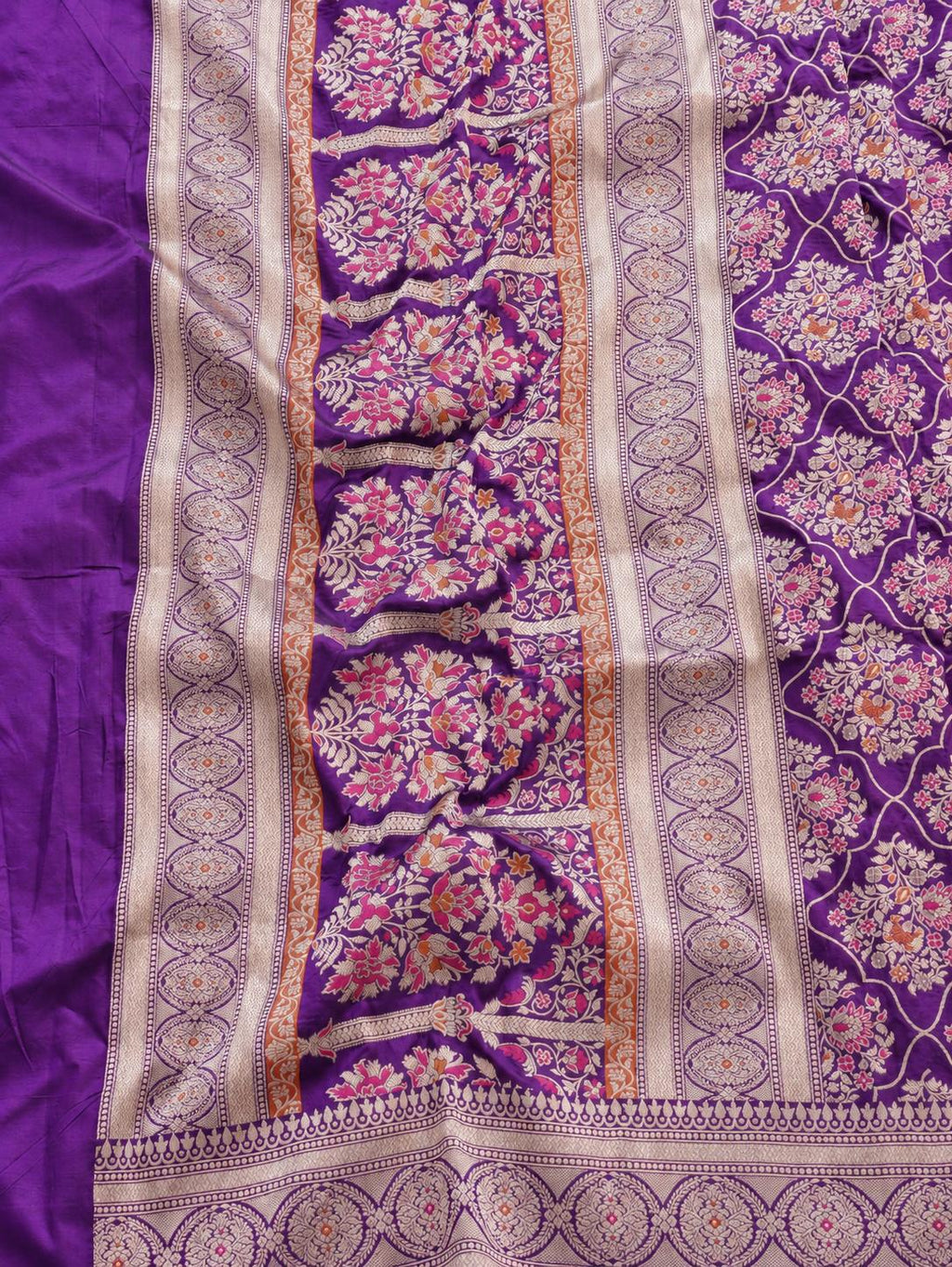 Rich royal purple with pale gold toned zari and vibrant pink and rust-orange floral accents Katan Silk Banarasi saree pallu detail