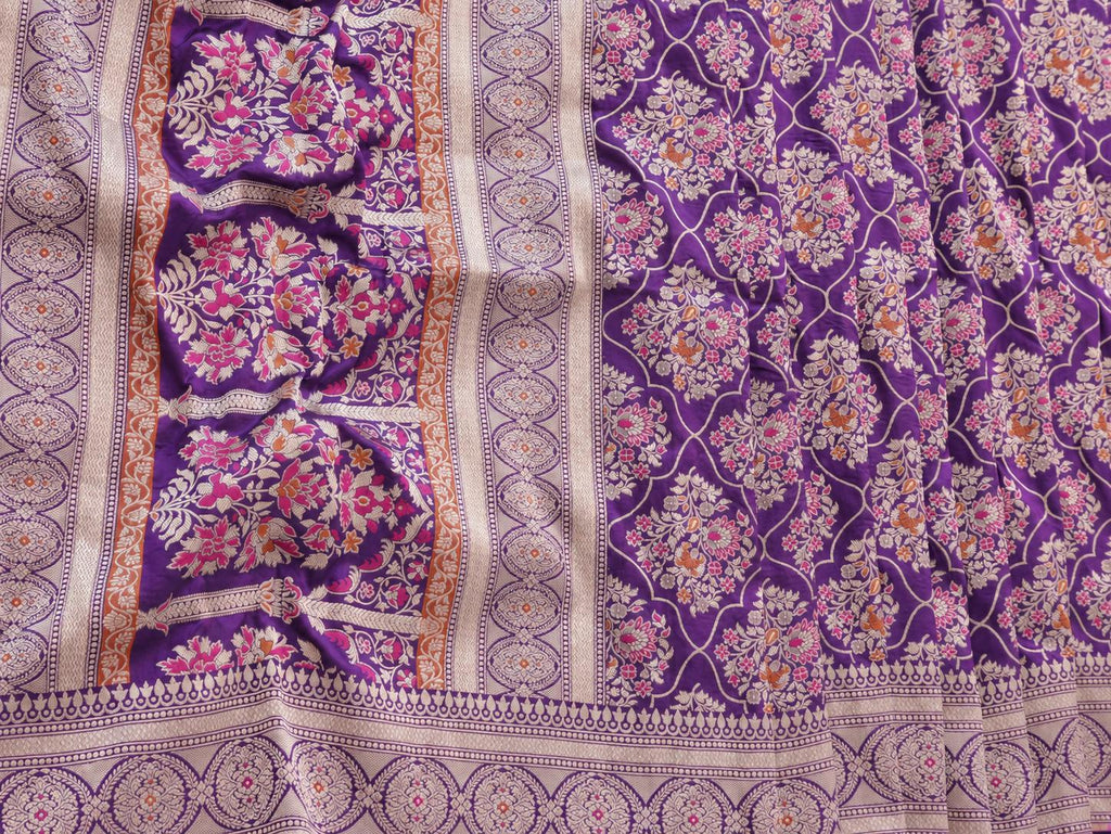 Rich royal purple with pale gold toned zari and vibrant pink and rust-orange floral accents Katan Silk Banarasi saree folded view