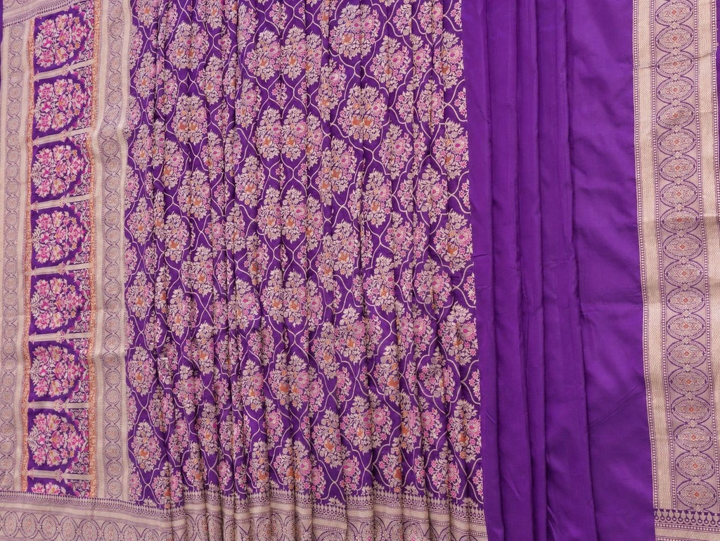 Rich royal purple with pale gold toned zari and vibrant pink and rust-orange floral accents Katan Silk Banarasi saree texture detail