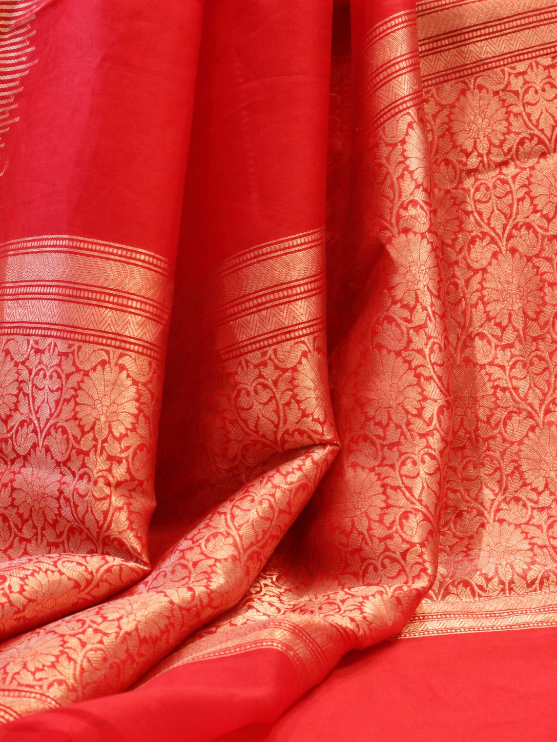 Vibrant vermilion red Kora Silk Banarasi saree border closeup