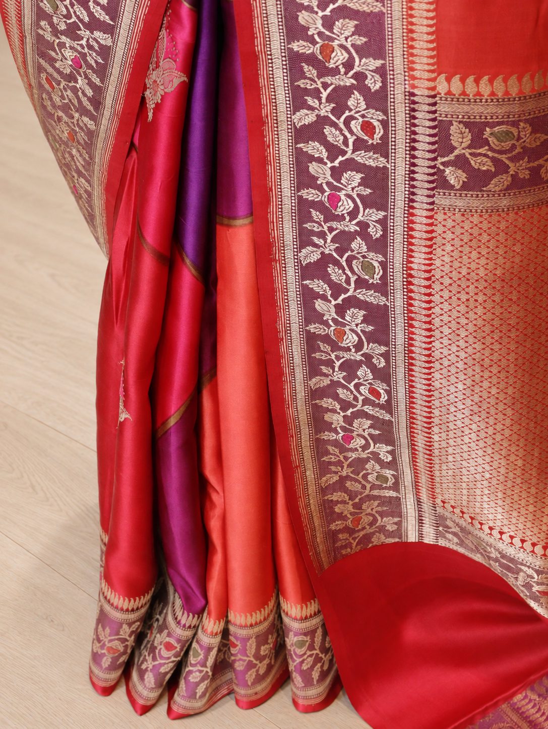 Wine magenta with contrasting red, orange and pink sections, highlighted by gold-toned zari. Katan Silk Banarasi saree full spread