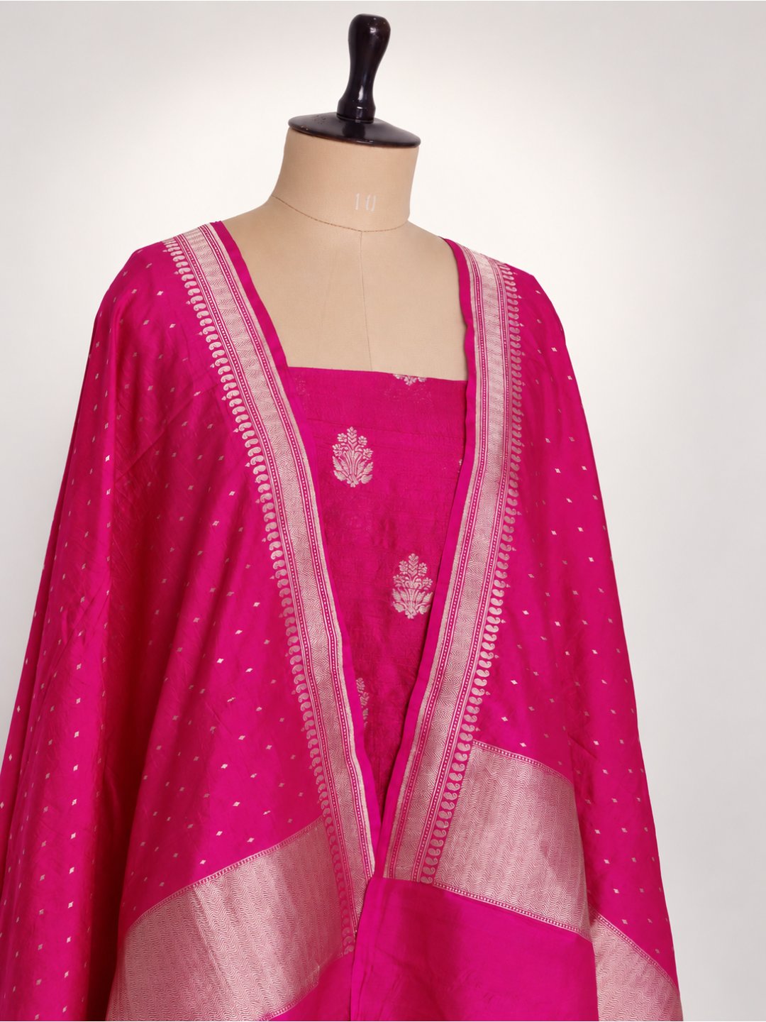 Rani pink with light gold zari. Dupion silk Banarasi suit border closeup