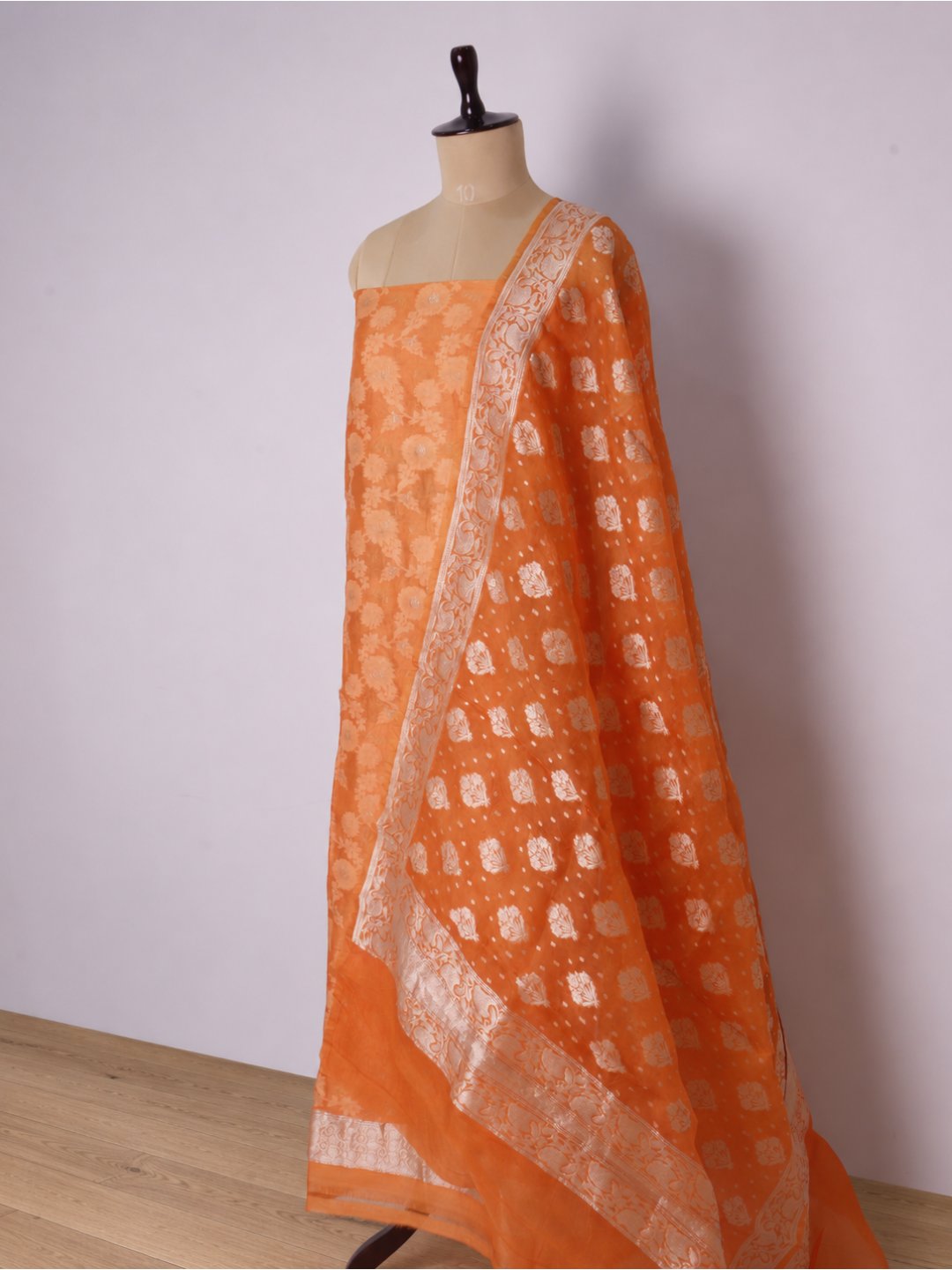 Warm orange with light gold-toned zari work. Chanderi suit Banarasi suit front drape view