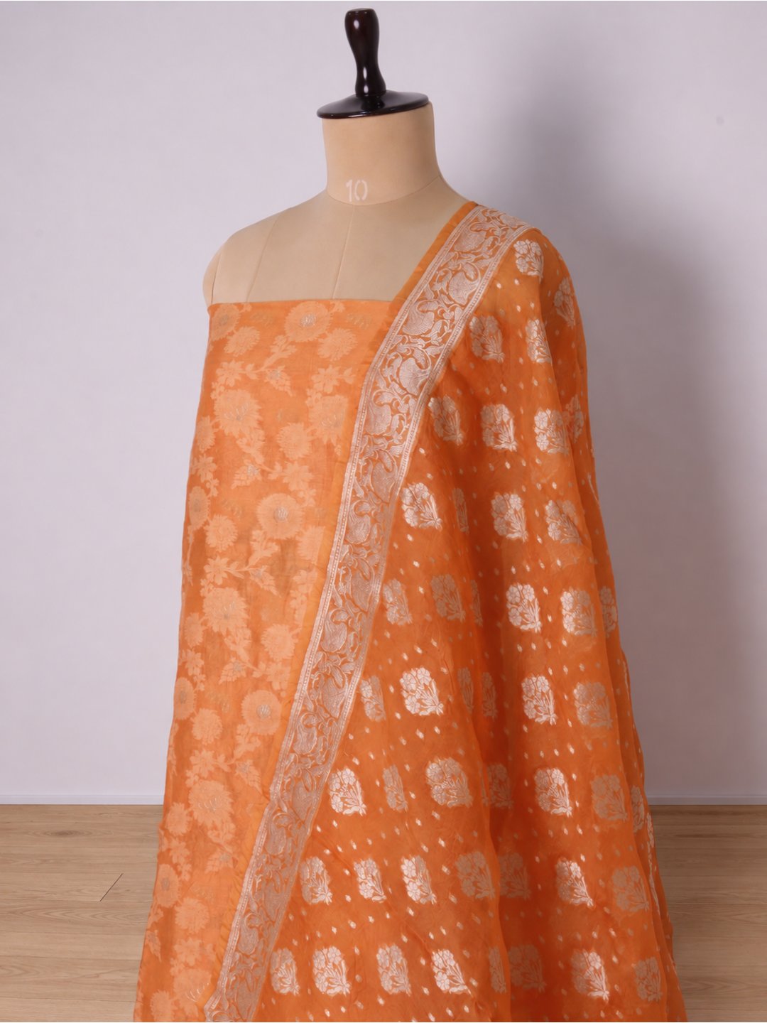 Warm orange with light gold-toned zari work. Chanderi suit Banarasi suit bottom detail