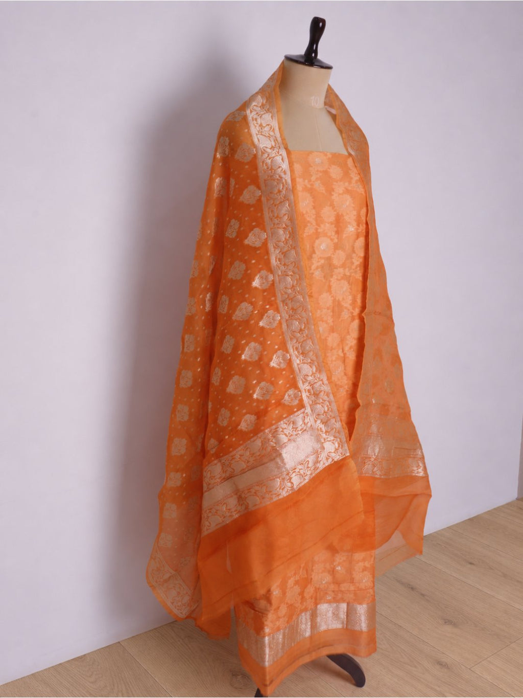 Warm orange with light gold-toned zari work. Chanderi suit Banarasi suit dupatta detail