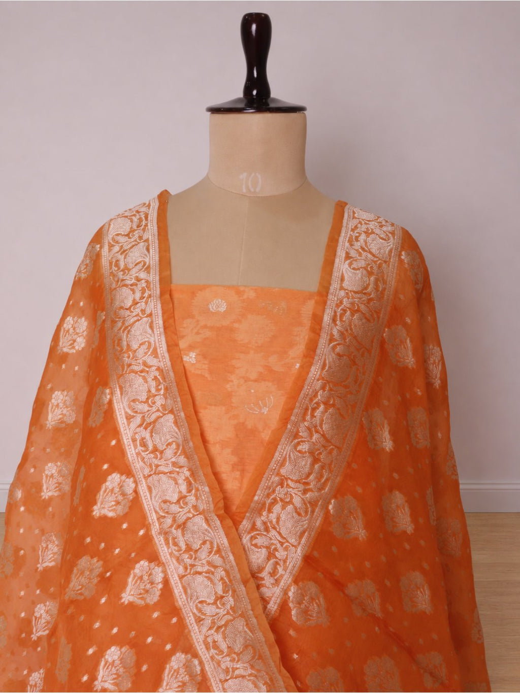Warm orange with light gold-toned zari work. Chanderi suit Banarasi suit border closeup
