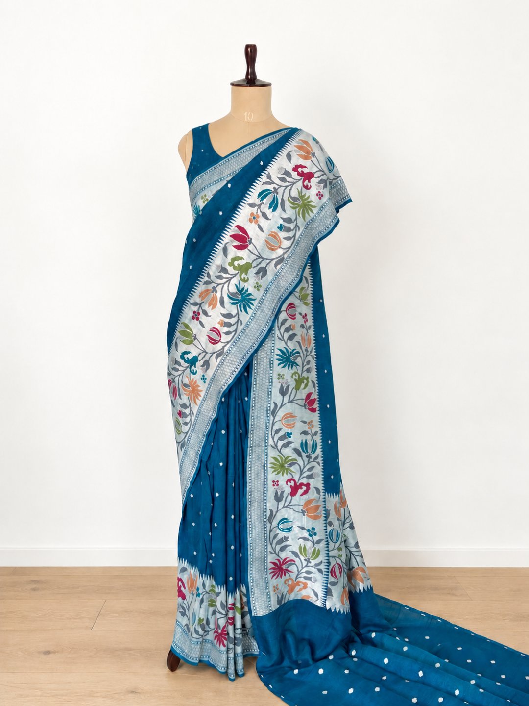 Teal blue with silver-toned zari and pink, peach, green and teal detailing. Tussar Silk Banarasi saree front drape view
