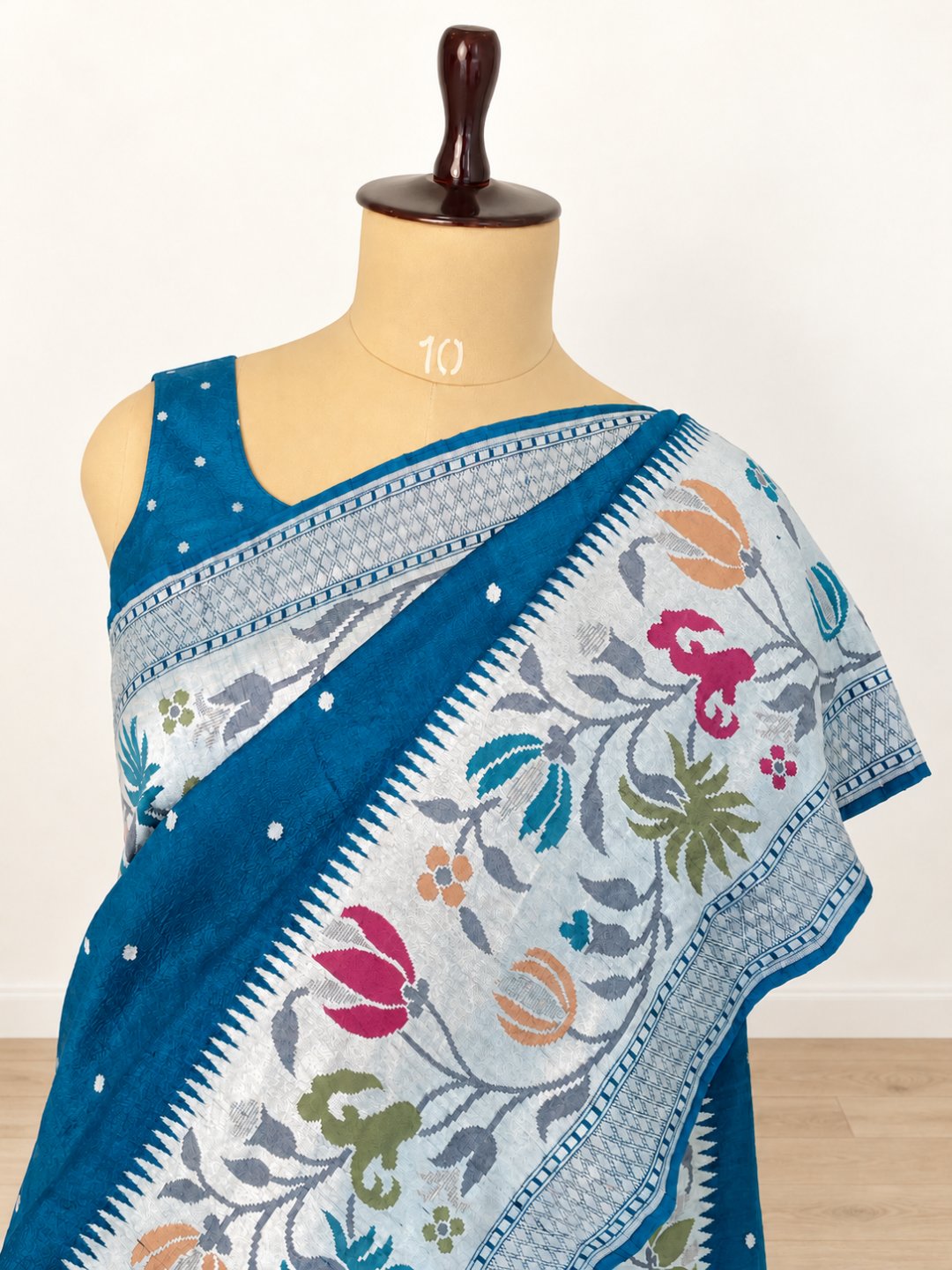 Teal blue with silver-toned zari and pink, peach, green and teal detailing. Tussar Silk Banarasi saree front drape view