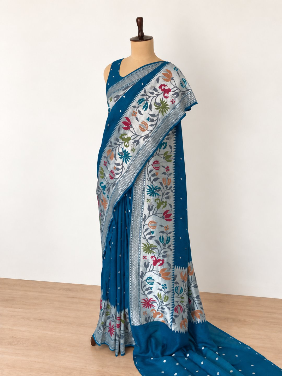Teal blue with silver-toned zari and pink, peach, green and teal detailing. Tussar Silk Banarasi saree front drape view