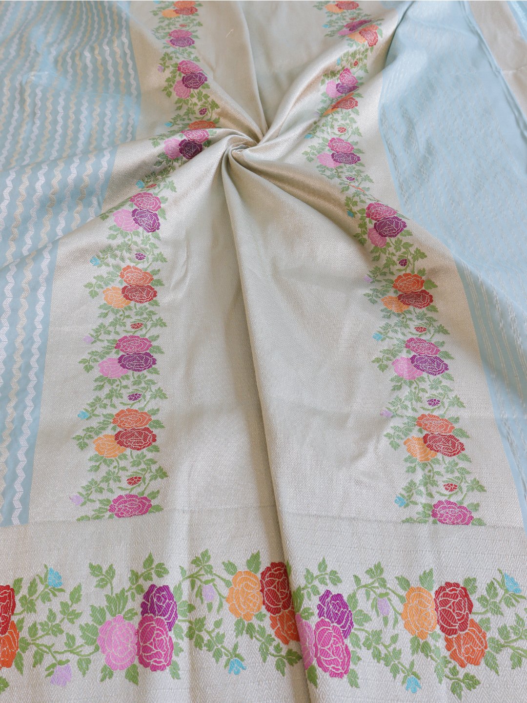 Powder aqua blue with a cream-gold border Katan Silk Banarasi saree folded view