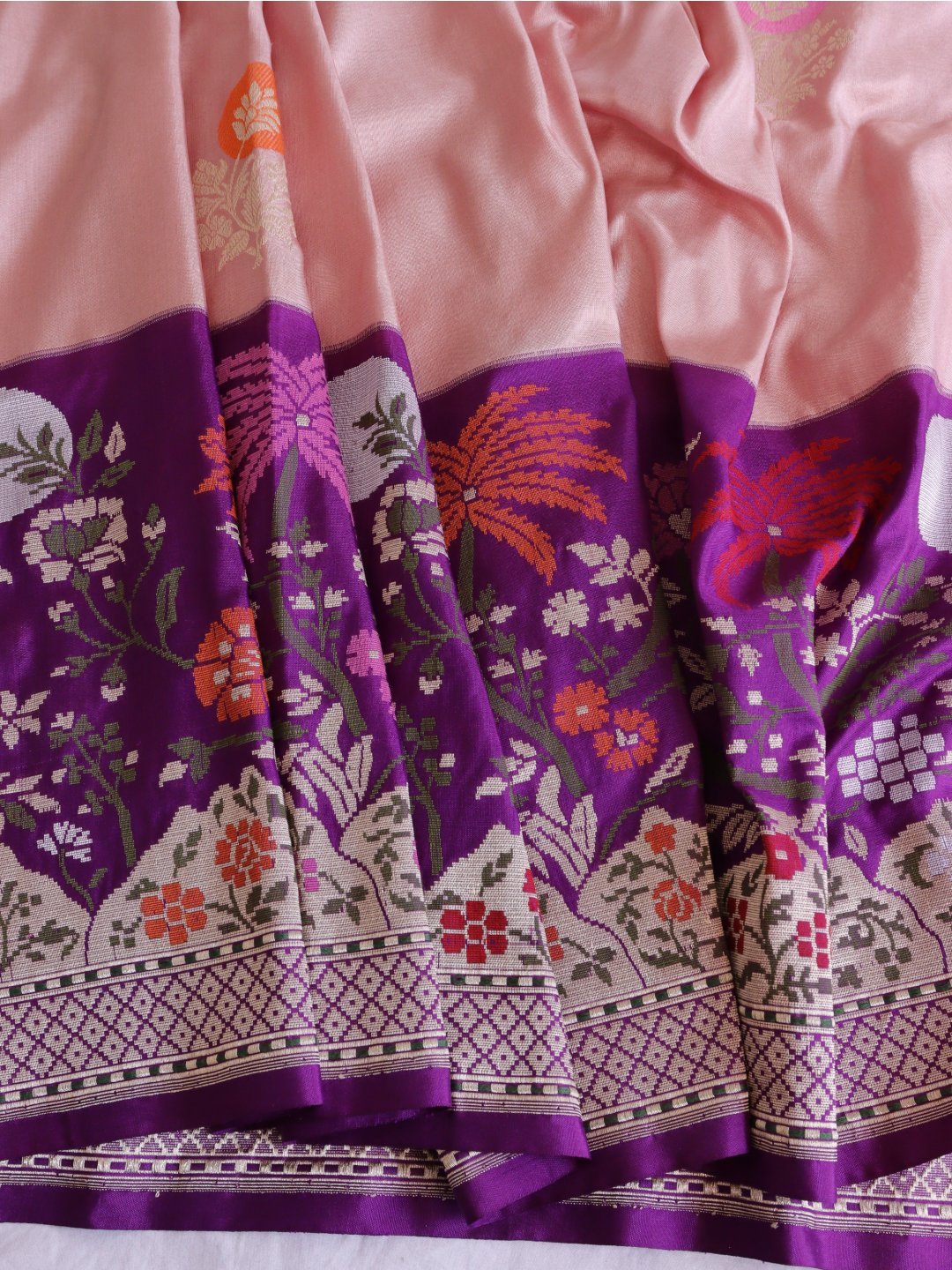 Soft peach-pink body with a rich purple borde Katan Silk Banarasi saree texture detail